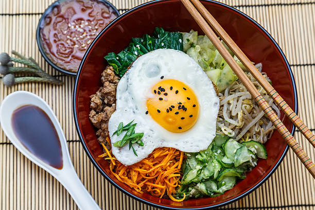 istock bibimbap in a bowl, korean dish top view 491410870