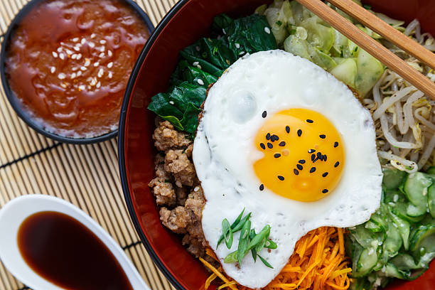 istock Korean cuisine, beef  Bibimbap in a clay pot on bamboo 491410982