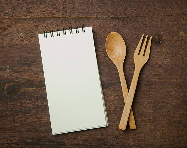 istock recipe book and spoon,fork on wooden table. 491412682