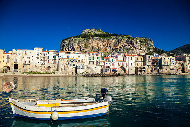 istock boat drifting in a harbor of Cefalu 491424286