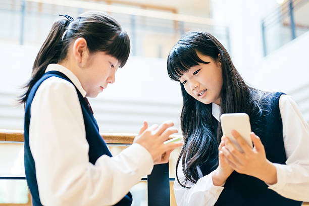 istock Japanese High School Girl Students using Smartphones at school 491424988