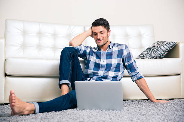 istock Man sitting on the floor with laptop 491425276