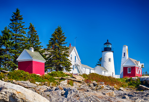 The Pemaquid Point Lighthouse in Bristol, Maine on a sunny day.