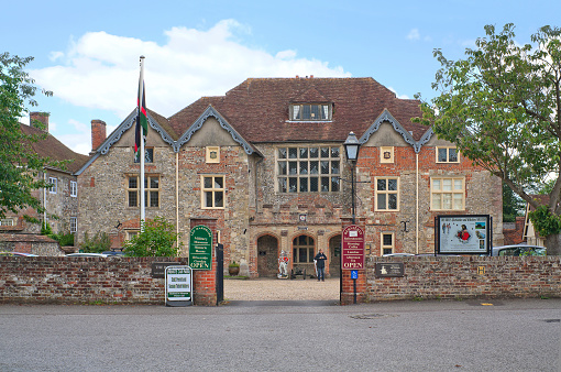 Salisbury, United Kingdom - August 26, 2012: Historical and military museum of the city with a man standing near the door