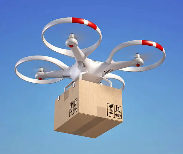 Photo of Drone with cardboard box in the sky