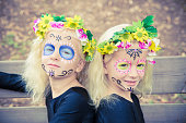 Cute twin girls with sugar skull makeup