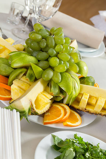 Cut fruit composition served on the table stock photo