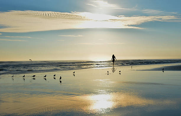 istock Woman walking on the beach. 491447592