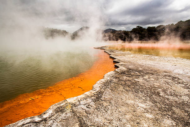 Champagne Pool, Waiotapu, New Zealand Champagne Pool, Waiotapu Thermal Wonderland, New Zealand. A natural geothermal hot pool and tourist attraction. Steam rises from the heat of the water, different minerals colouring the scene. whakarewarewa stock pictures, royalty-free photos & images