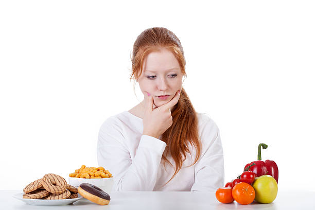 istock Wondering whether to eat sweets or vegetables 491448511