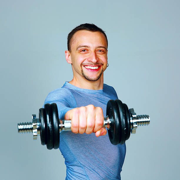 istock Happy man working out with dumbbells 491448563