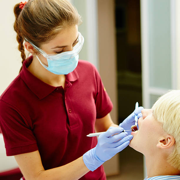 istock Dentist curing a female patient 491448938