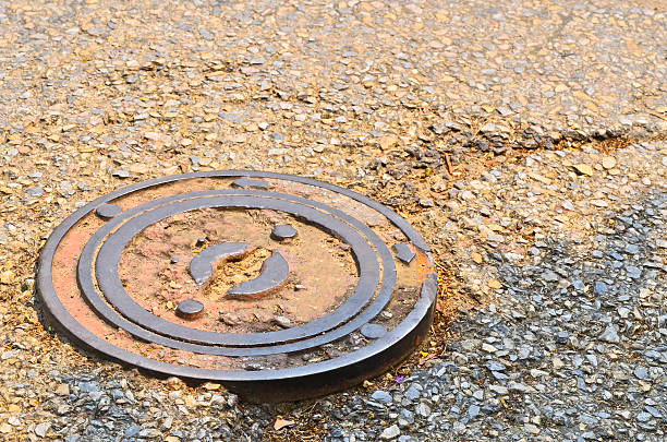 istock Water manhole cover on road 491449127