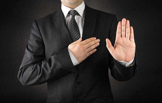 Men in suits taking oath Men in suits taking oath         commits stock pictures, royalty-free photos & images