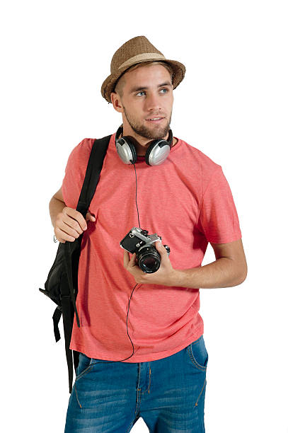 Young handsome tourist traveling with camera and backpack