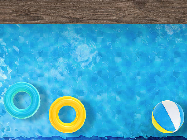 istock pool top view with swim rings and beach ball 491451346