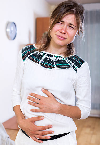 istock Adult female with abdominal pains 491464100