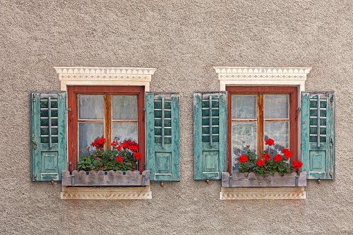 Two ornate windows with sgraffitos at an old house in Tschlin (Graubunden Canton, Switzerland).