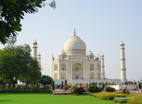 Agra, India - July 13, 2015: People visit Taj Mahal in Agra, India. The Taj Mahal is a mausoleum located in Agra, India and is one of the most recognizable structures in the world.