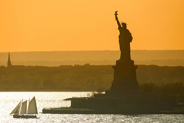 Aerial view of Statue of Liberty on Liberty Island and city at background in Lower Manhattan, New York City, New York State, USA.