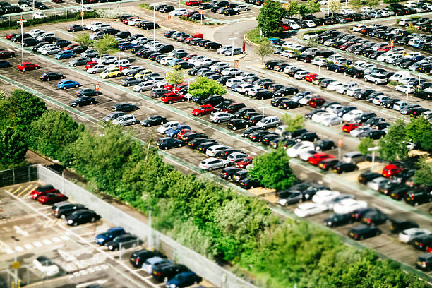 Aerial view of an airport parking lot, London Heathrow An aerial view of an airport car park, taken from within an aeroplane, London Heathrow.  Daylight, nobody, horizontal composition.   heathrow airport stock pictures, royalty-free photos & images