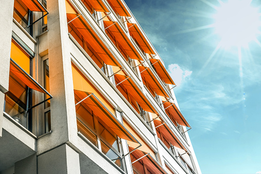 modern residential house with orange awnings in sunny Berlin