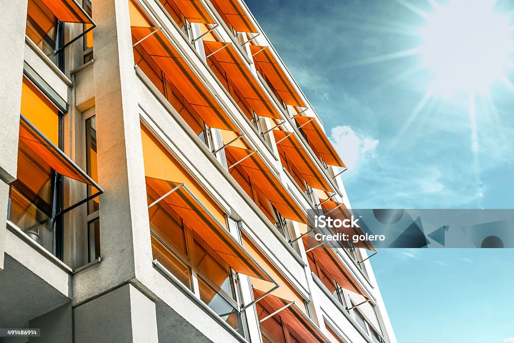 modern residential house with orange awnings in sunny Berlin Awning Stock Photo