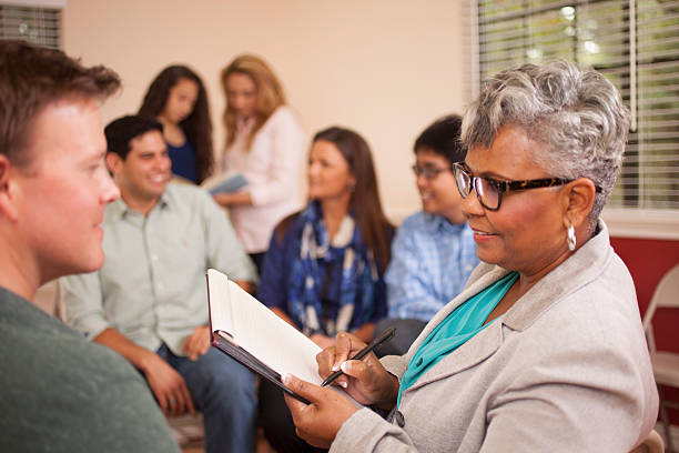 istock Multi-ethnic group of people in counseling session with therapist. 491488132