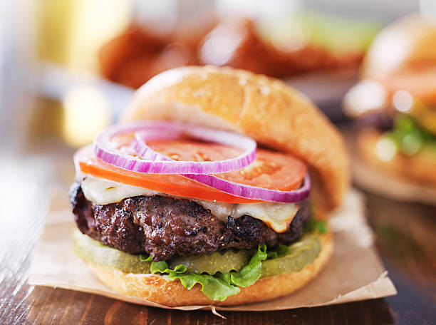 istock cheeseburgers with wings and beer 491496912