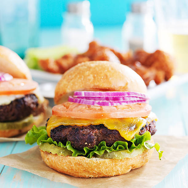 istock thick cheeseburgers on colorful table top 491496936