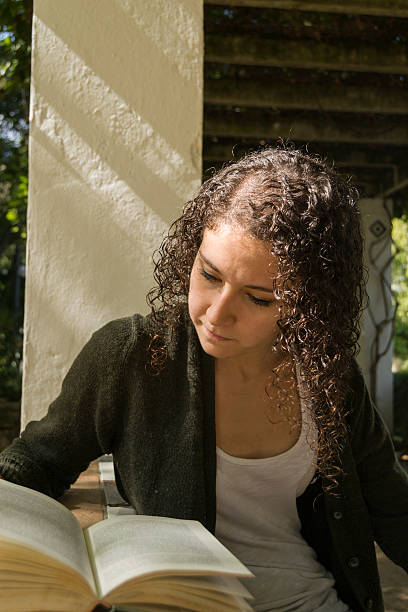 istock Young woman reading a book in autumn 491498680