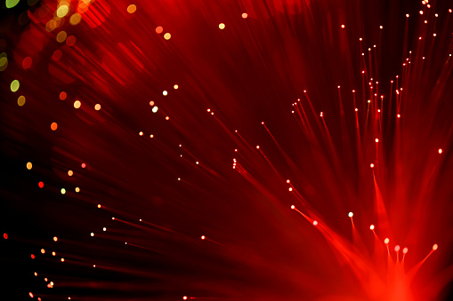 Fiber optics abstract red background. Defocused lights and lines create the motion blur effect.