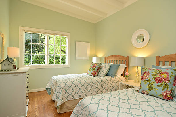 Traditional colorful bedroom with bed, pillows and towels