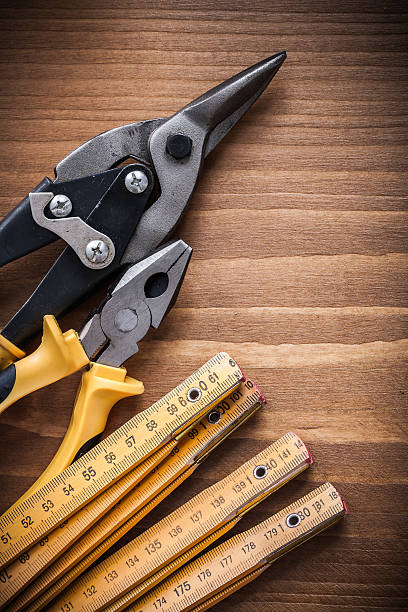 istock Composition of tin snips pliers wooden meter construction concep 491499642