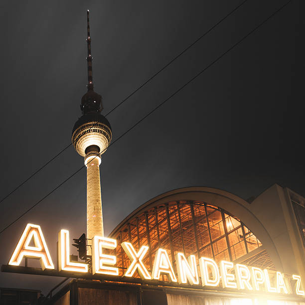 Scenic View Famous Alexanderplatz TV Tower of Berlin, Germany in Modern Futuristic Purple Light Color surrounded by Fog at Night, Close up View of Antenna HQ