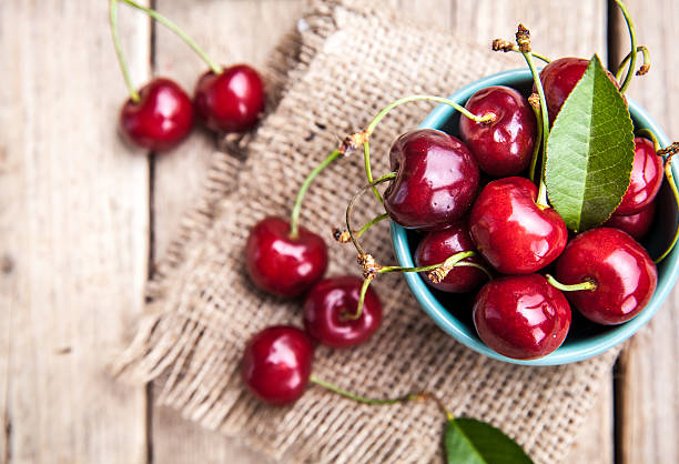 istock Cherry isolated on wooden background 491499684