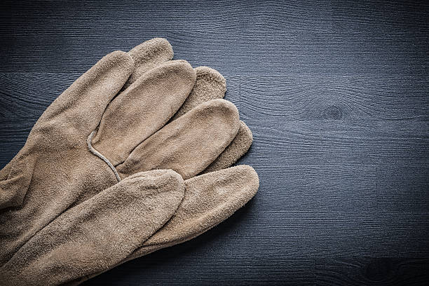 istock two protective gloves on dark wood board 491500664