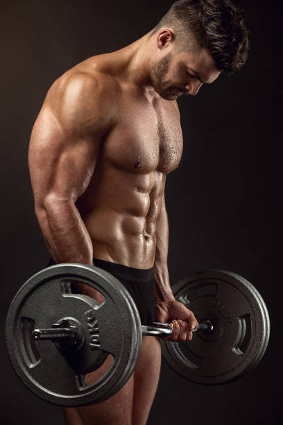 istock Muscular bodybuilder guy doing exercises with big dumbbell 491500812