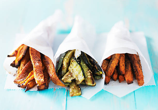 trio of carrot, zucchini, and sweet potato fries trio of carrot, zucchini, and sweet potato fries shot head on sweet potato french fries stock pictures, royalty-free photos & images