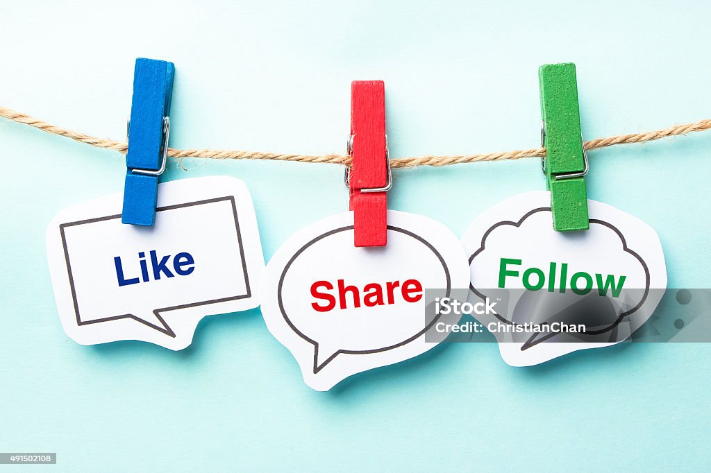 Like share follow Like share follow bubble with clip hanging on the line with blue background. Social Media Stock Photo