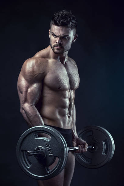 istock Muscular bodybuilder guy doing exercises with big dumbbell 491511362