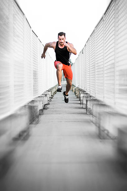 Run. Fast. Runner practising in urban environment. hard and fast stock pictures, royalty-free photos & images