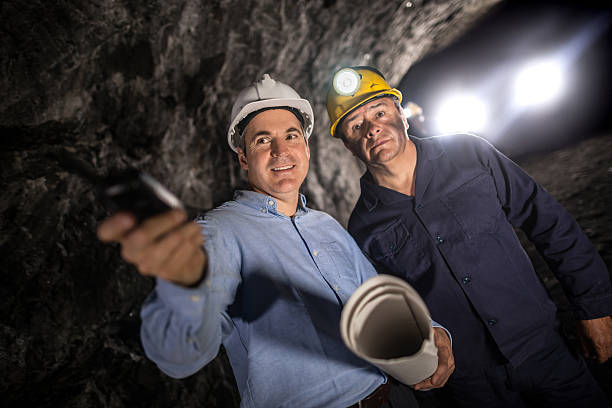 istock Engineer working at a mine and talking to a miner 491514608