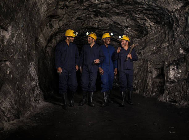 istock Group of miners talking and walking underground 491515574