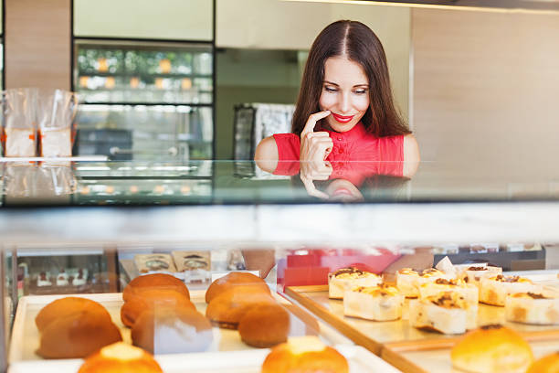 istock woman choosing bakery items in a shop 491516782
