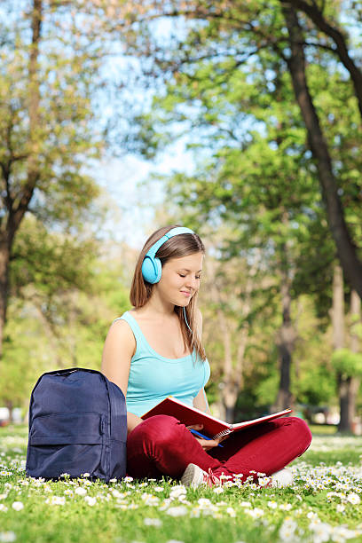istock Young woman studying in park 491517181