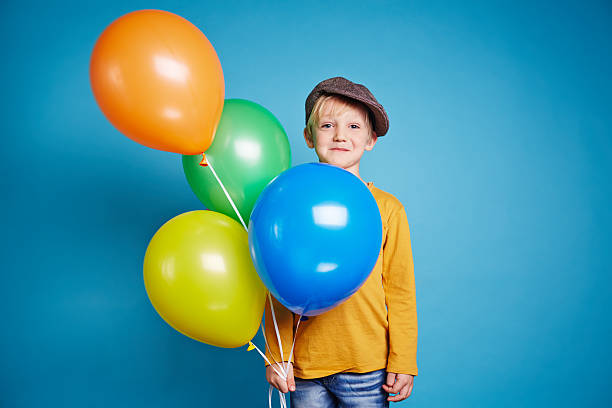istock Boy holding balloons 491517226