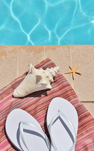 istock Swimming pool Holiday shoes sarong shells 491517411