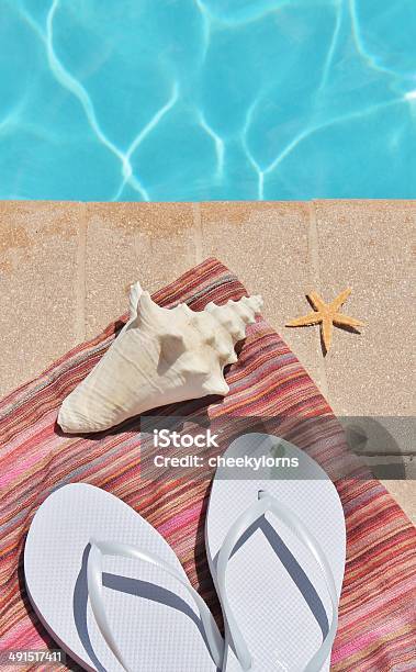 Swimming Pool Holiday Shoes Sarong Shells Stock Photo - Download Image Now - Blue, Concepts, Conch Shell