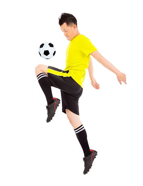 soccer player jumping to stop the ball
